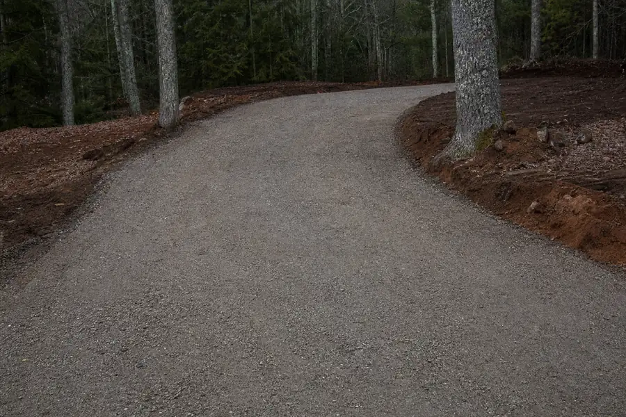 Freshly graded ABC stone driveway base compacted smooth before gravel topping in North Carolina