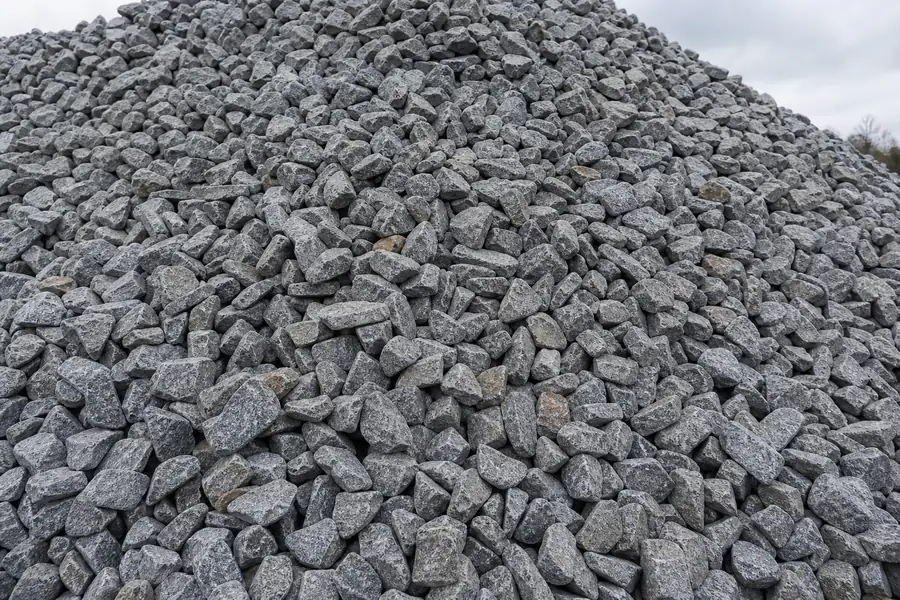 Close pile of angular gray number 57 crushed stone ready for delivery